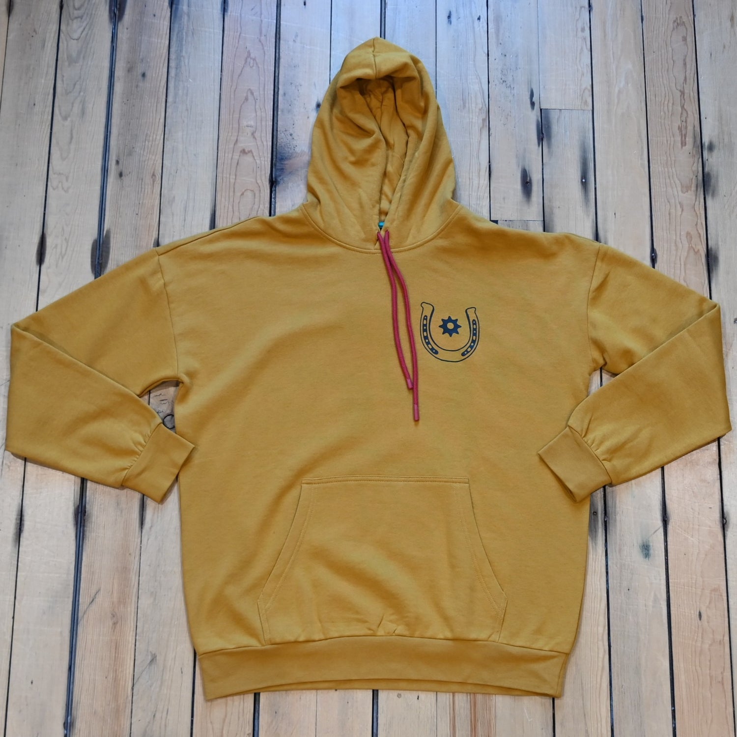 Goldenrod Sendero No Luck hoodie with horseshoe graphic and Sendero Provisions logo