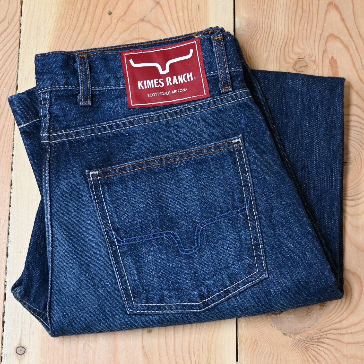 View of Kimes Ranch Dillon Jeans in Blue, featuring a mid-low rise, relaxed upper thigh, and wide bootcut leg with hand-sanded details
