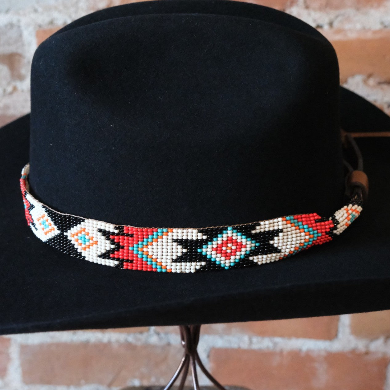 Adjustable Sambboho Phoenix beaded hatband styled on a western felt hat at Atomic 79.