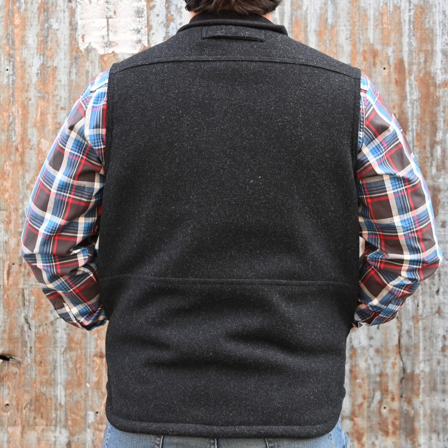 View of Filson Lined Mackinaw Wool Work Vest in Dark Spruce and Charcoal featuring zipper-front closure, wool-blend rib-knit collar, and multiple pockets