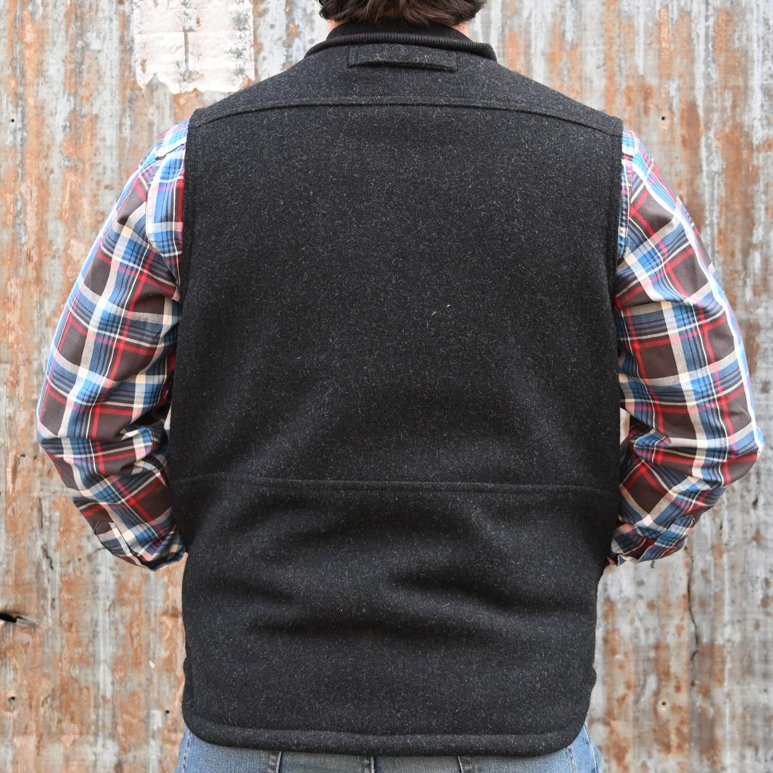 View of Filson Lined Mackinaw Wool Work Vest in Dark Spruce and Charcoal featuring zipper-front closure, wool-blend rib-knit collar, and multiple pockets