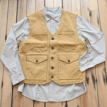 View of Schaefer brushcloth vest in suntan canvas with utility pockets and brass buttons