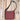 Gun Toten Mamas conceal carry Slim Cross-Body bag in cinnamon leather with black trim