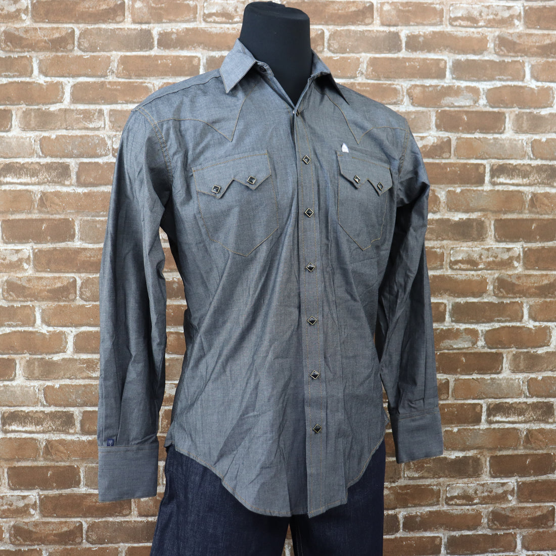 View of Rockmount black chambray western shirt with sawtooth pockets and gold diamond snaps