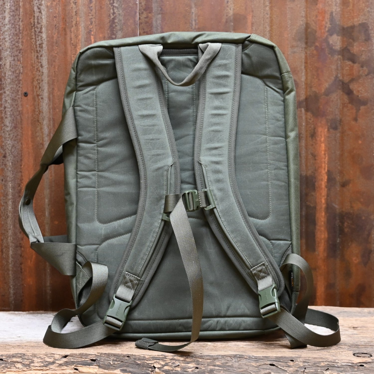 View of Filson Surveyor Pullman Pack in Service Green, showcasing its durable construction and spacious design