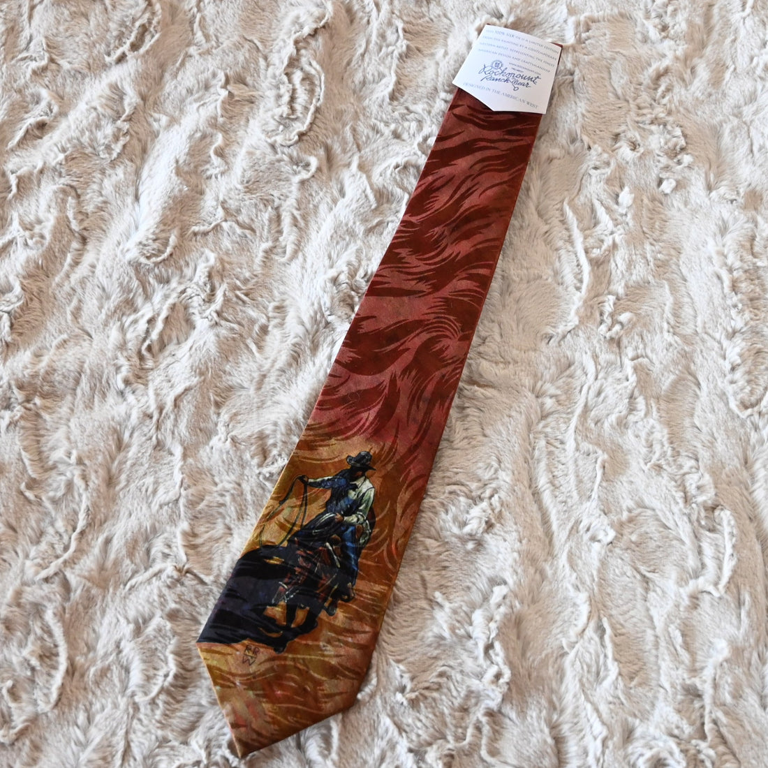 View of Silk necktie with cowboy on horseback roping, artwork by Howard Post