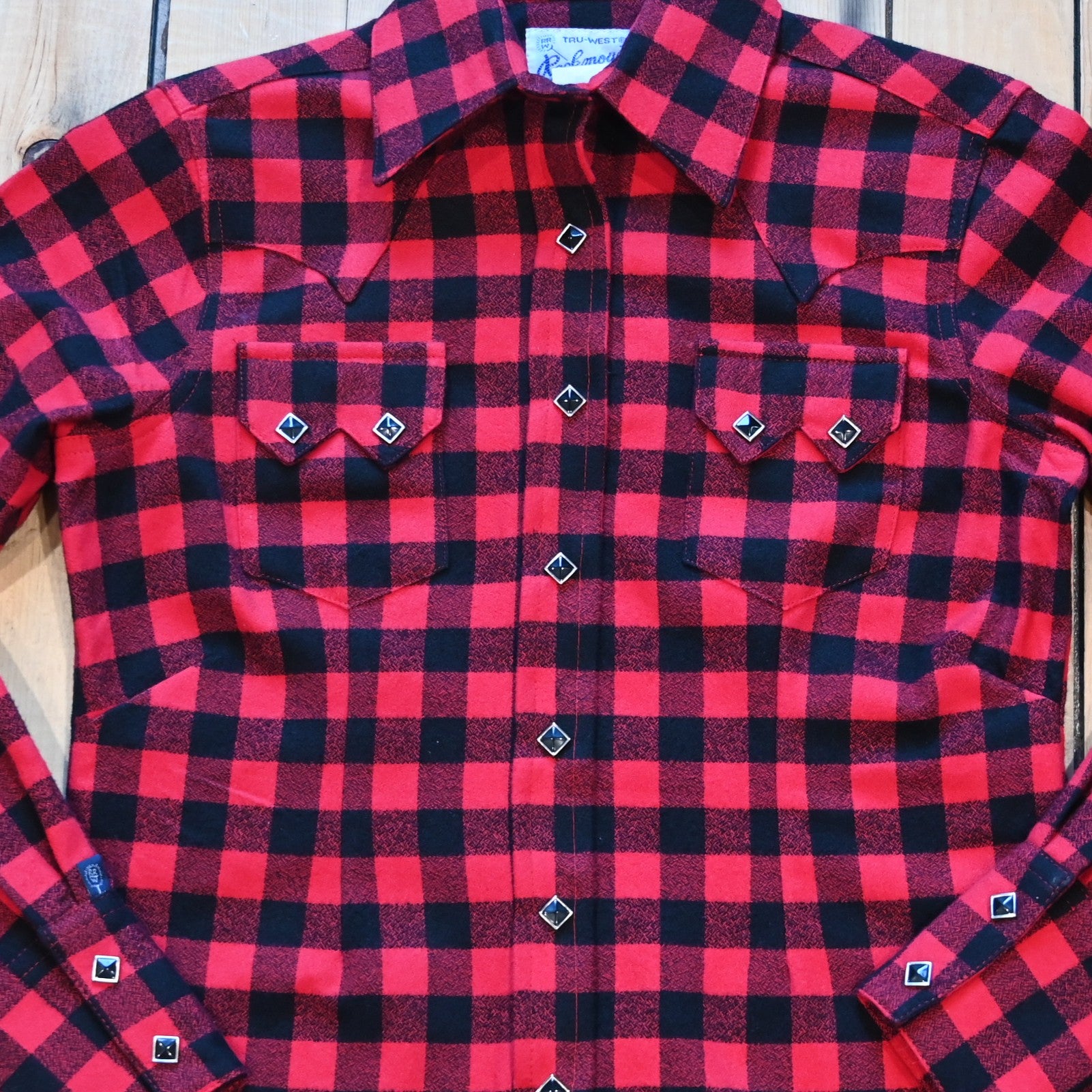 View of Ladies plush red and black buffalo check flannel Western shirt with sawtooth pockets and diamond snaps