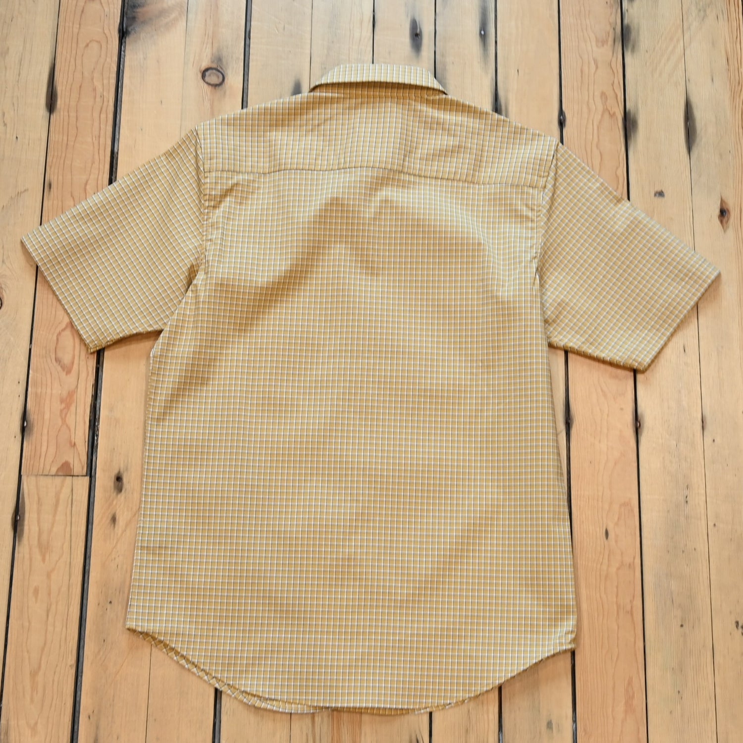 View of Kimes Ranch MC Cooper Short Sleeve Button-Up Shirt in Gold, featuring a grid plaid pattern and snap button front