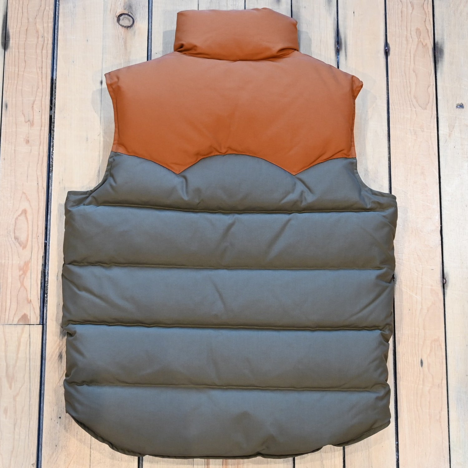 Schaefer Bozeman Down Vest in cedar color with nylon shell, insulated down fill, and storm flap zipper