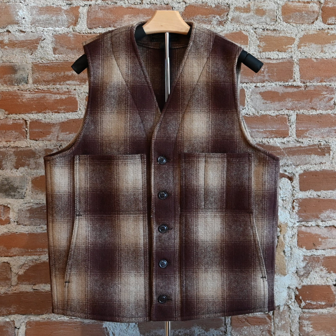 View of Filson Mackinaw Wool Vest in Brown/Tan Ombre featuring V-neckline, button-front closure, and multiple pockets