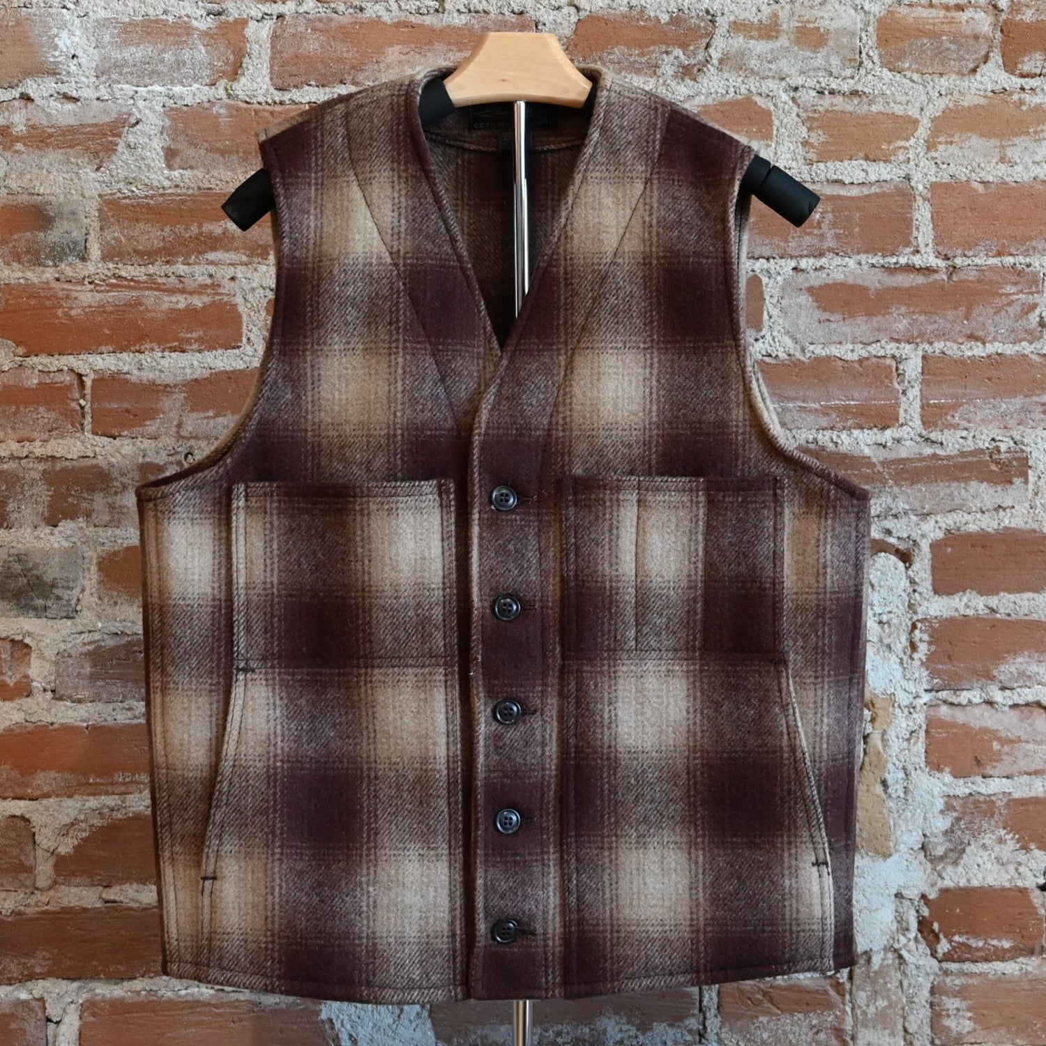 View of Filson Mackinaw Wool Vest in Brown/Tan Ombre featuring V-neckline, button-front closure, and multiple pockets