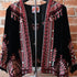 View of Johnny Was black velvet bolero with red and white embroidered floral trim