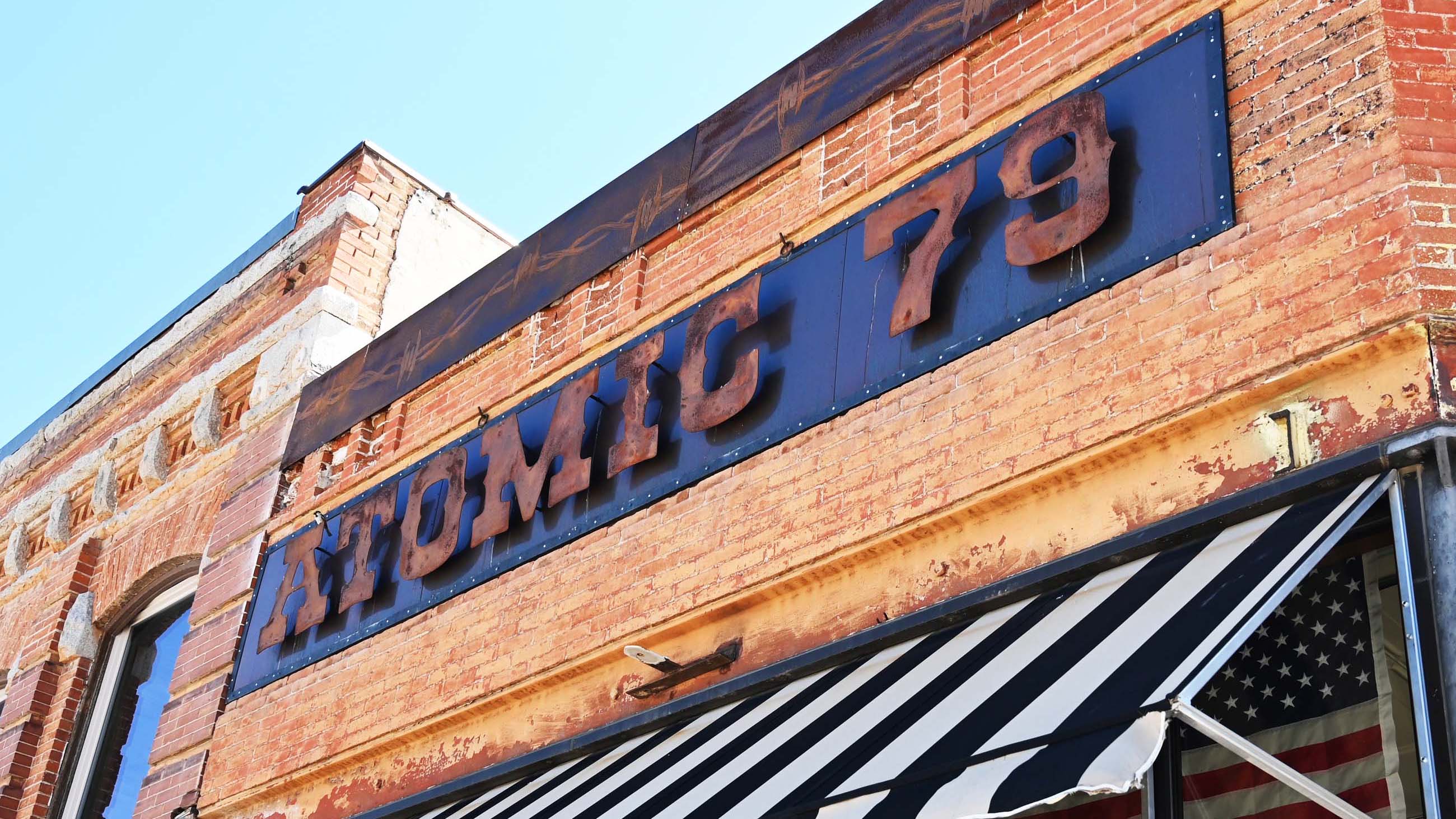 Photo of Atomic 79 western clothing store in Dillon, Montana with US flag displayed