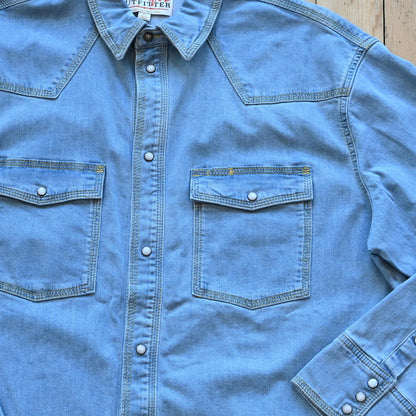 View of Schaefer denim snap shirt in dark indigo, gray, and light indigo with Western yokes and chest pockets