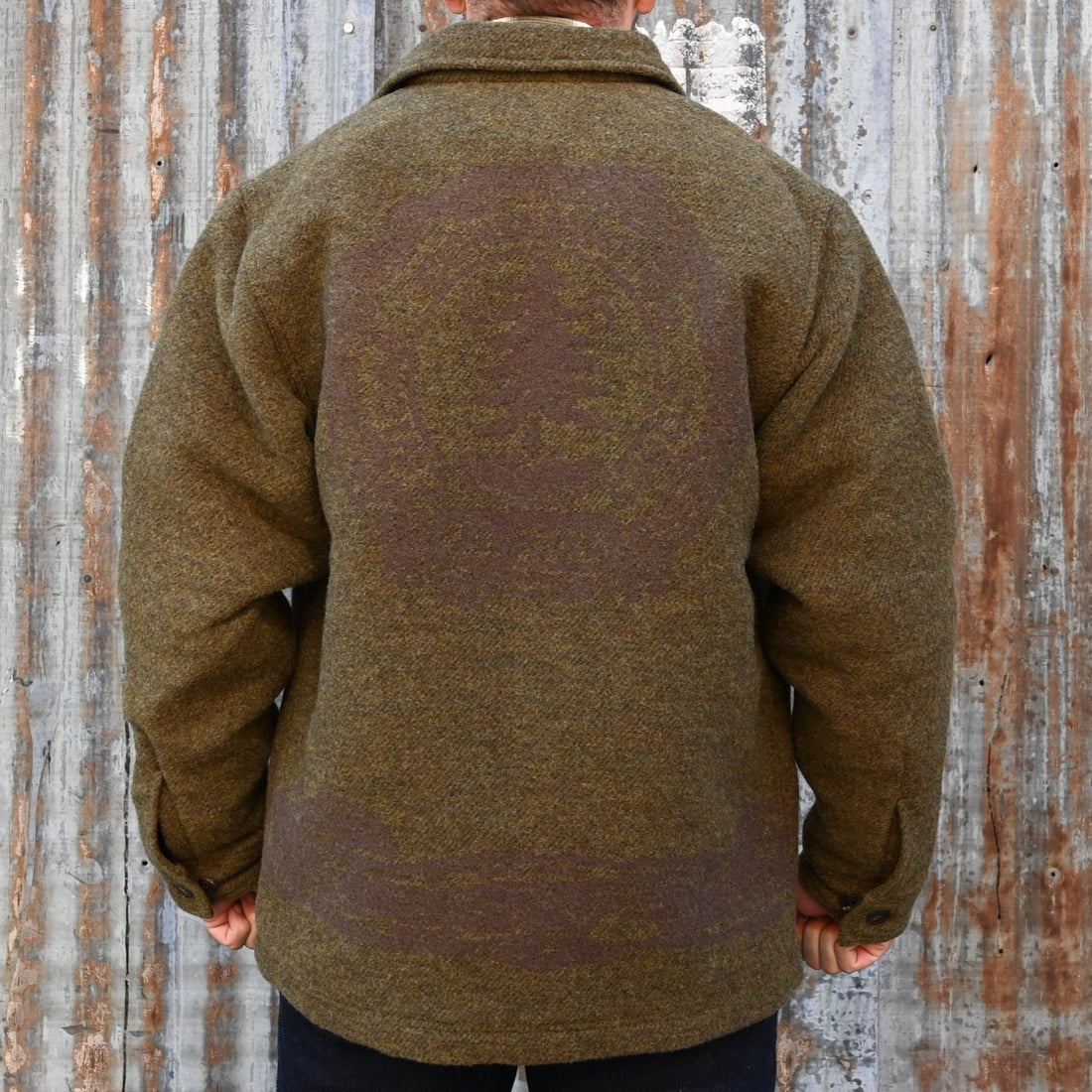 View of Filson CCC Jacquard Wool Jac-Shirt in Olive Brown Multi featuring large CCC emblem and natural horn buttons