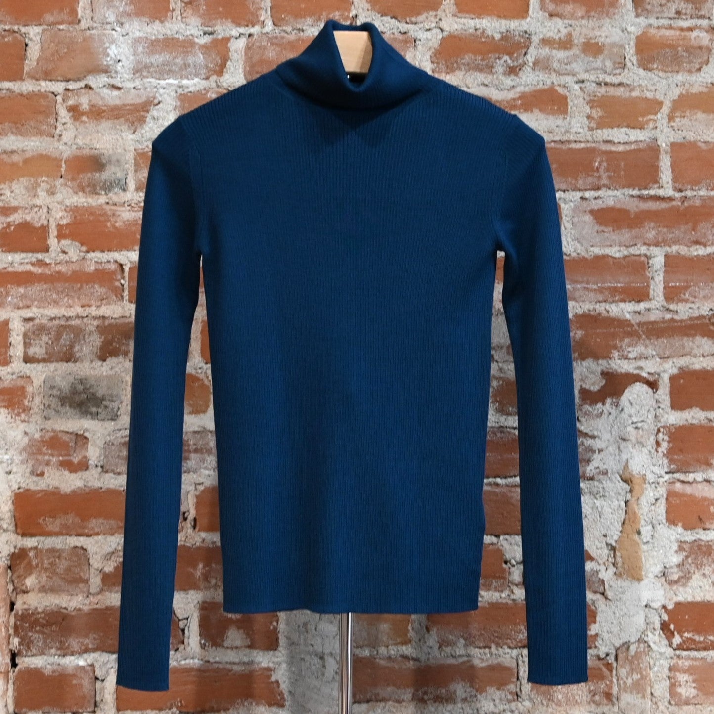 View of Pendleton rib merino turtleneck in Peacock Blue with slim fit and folded neck