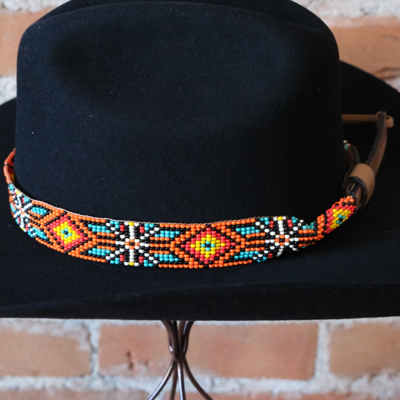 Adjustable Sambboho Maui beaded hatband styled on a western felt hat at Atomic 79.