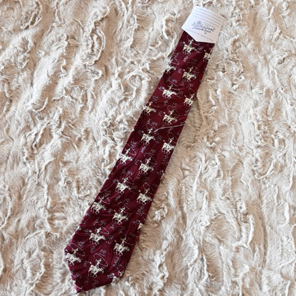 View of Rockmount burgundy silk necktie with roper figure and Tru‑West® branding