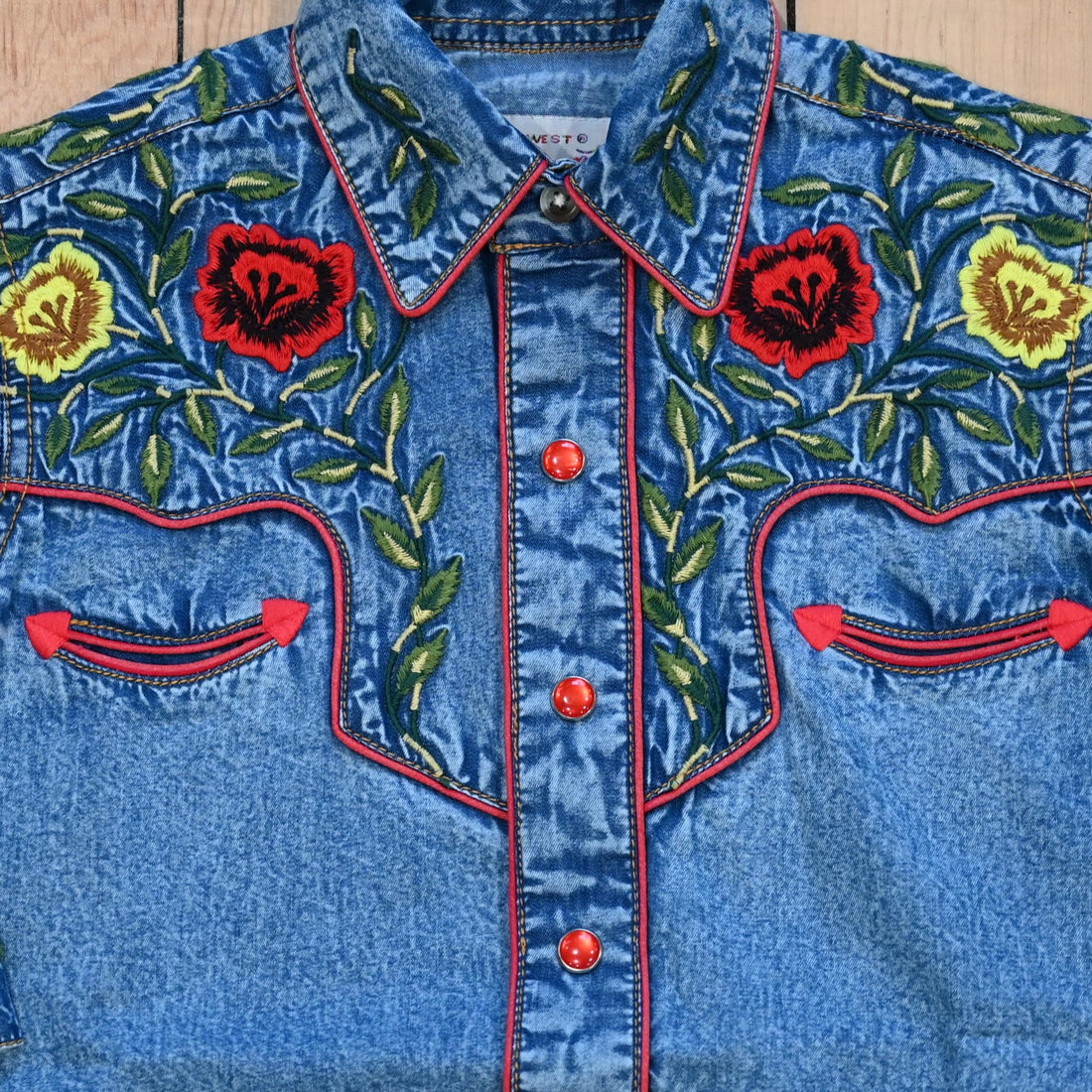 View of Rockmount kids denim shirt with red and yellow floral embroidery and western details