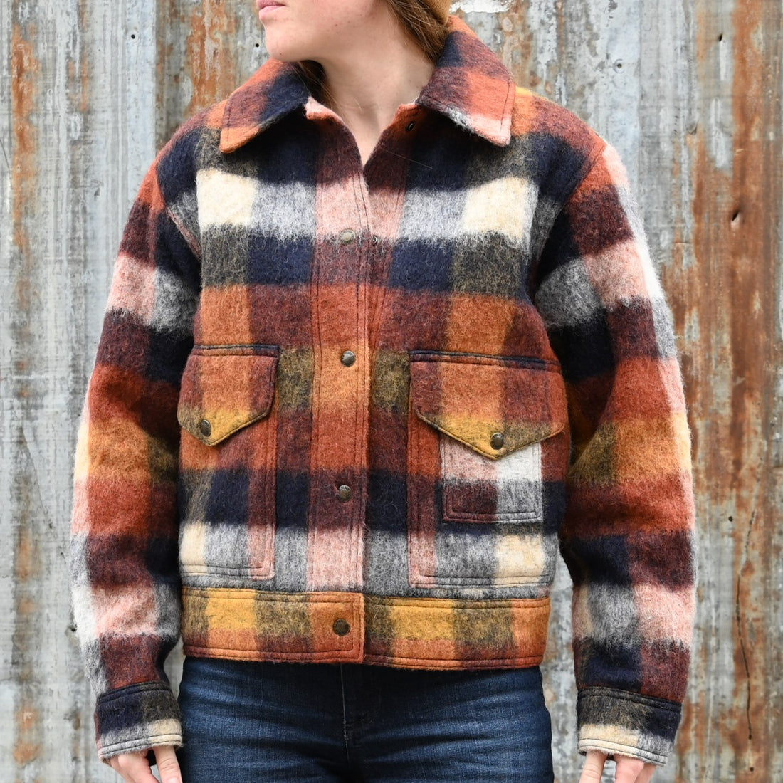 Filson Ladies Blanket Wool Heritage Jacket in red, orange, and black plaid with snap-front design