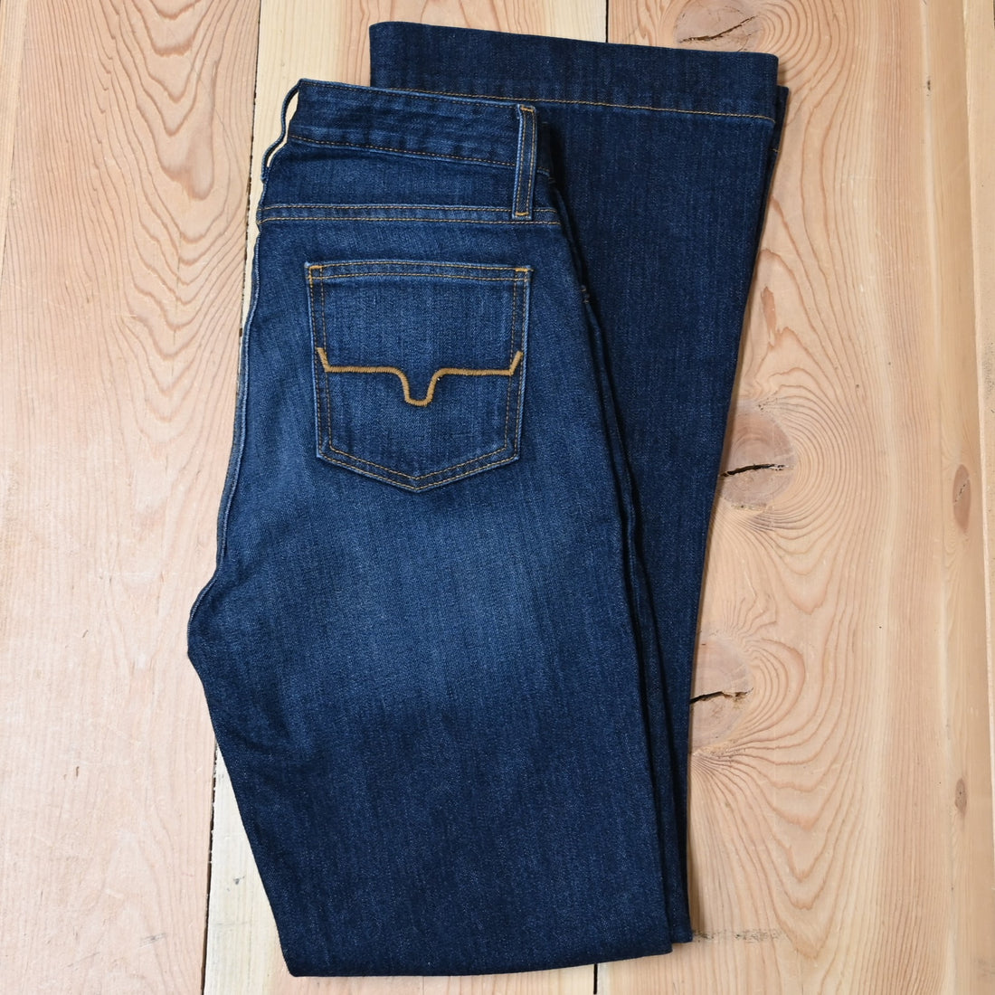 View of Kimes Ranch Jennifer Jeans in Dark Wash, featuring an ultra-high rise and super wide flare leg with hand-sanding and whisker details