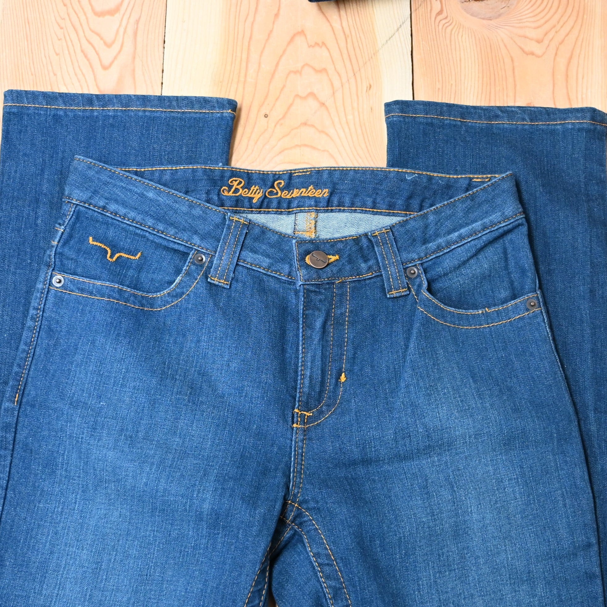 View of Kimes Ranch Betty17 Jeans in Blue, featuring embroidered horns on back pockets and a modest bootcut leg