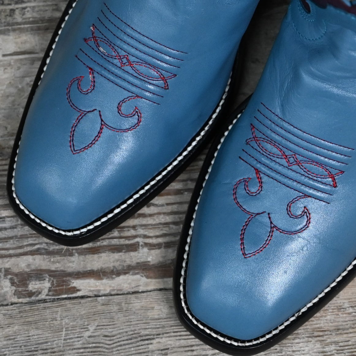 View of Atomic 79 exclusive Hondo Bronc Boot with burgundy top, sky blue vamp, French square toe, and spur lip