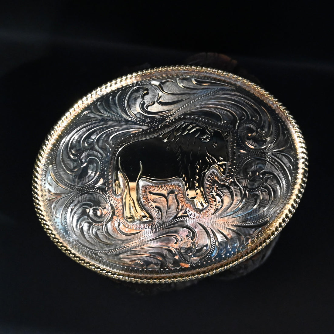 View of Sterling plate oval belt buckle with engraved bison and rope edge