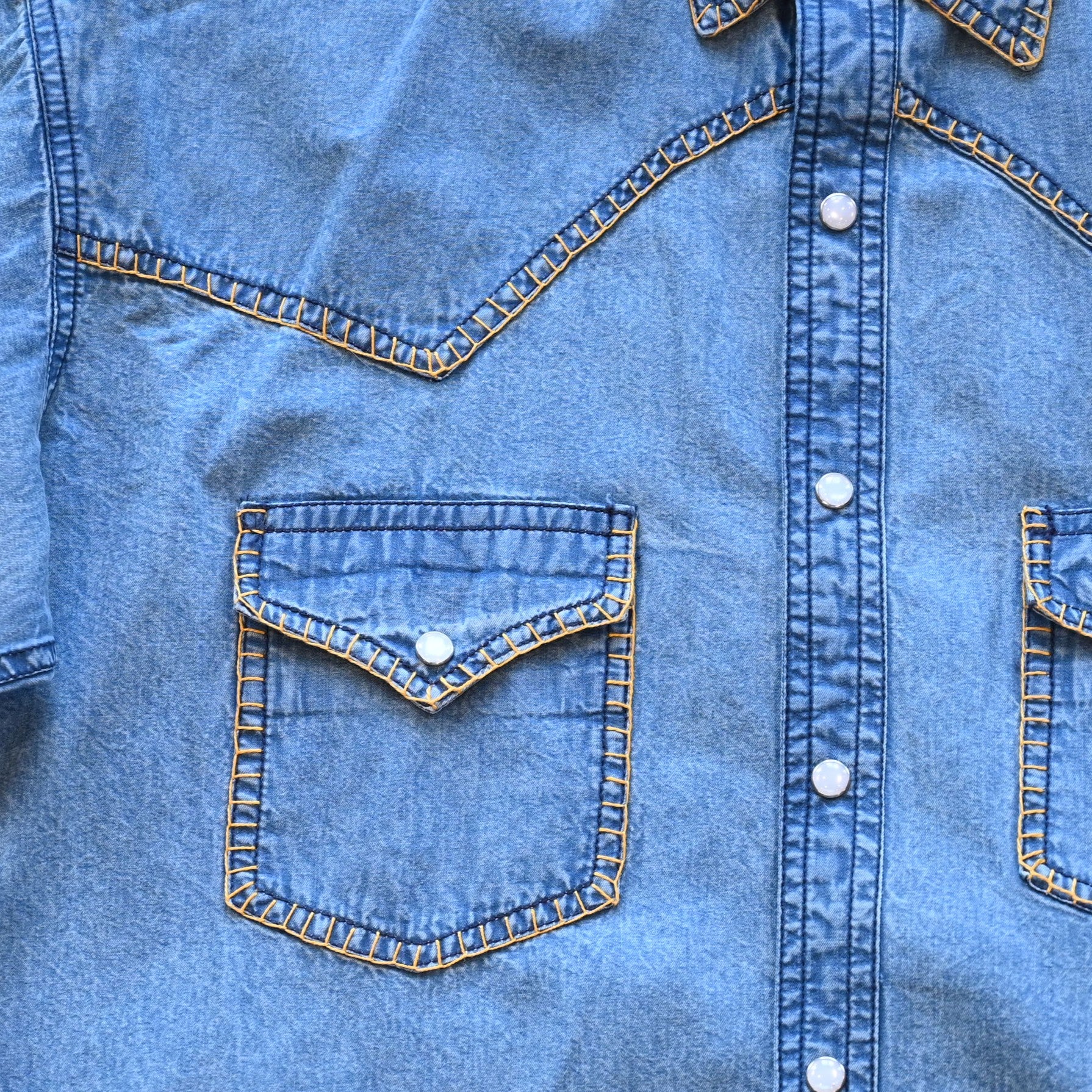 View of Rockmount men’s stonewashed denim Western shirt with blanket stitch detailing and snap front