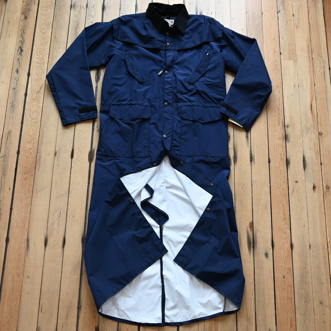 View of Navy waterproof Stockman duster by Schaefer with leather collar and storm flap