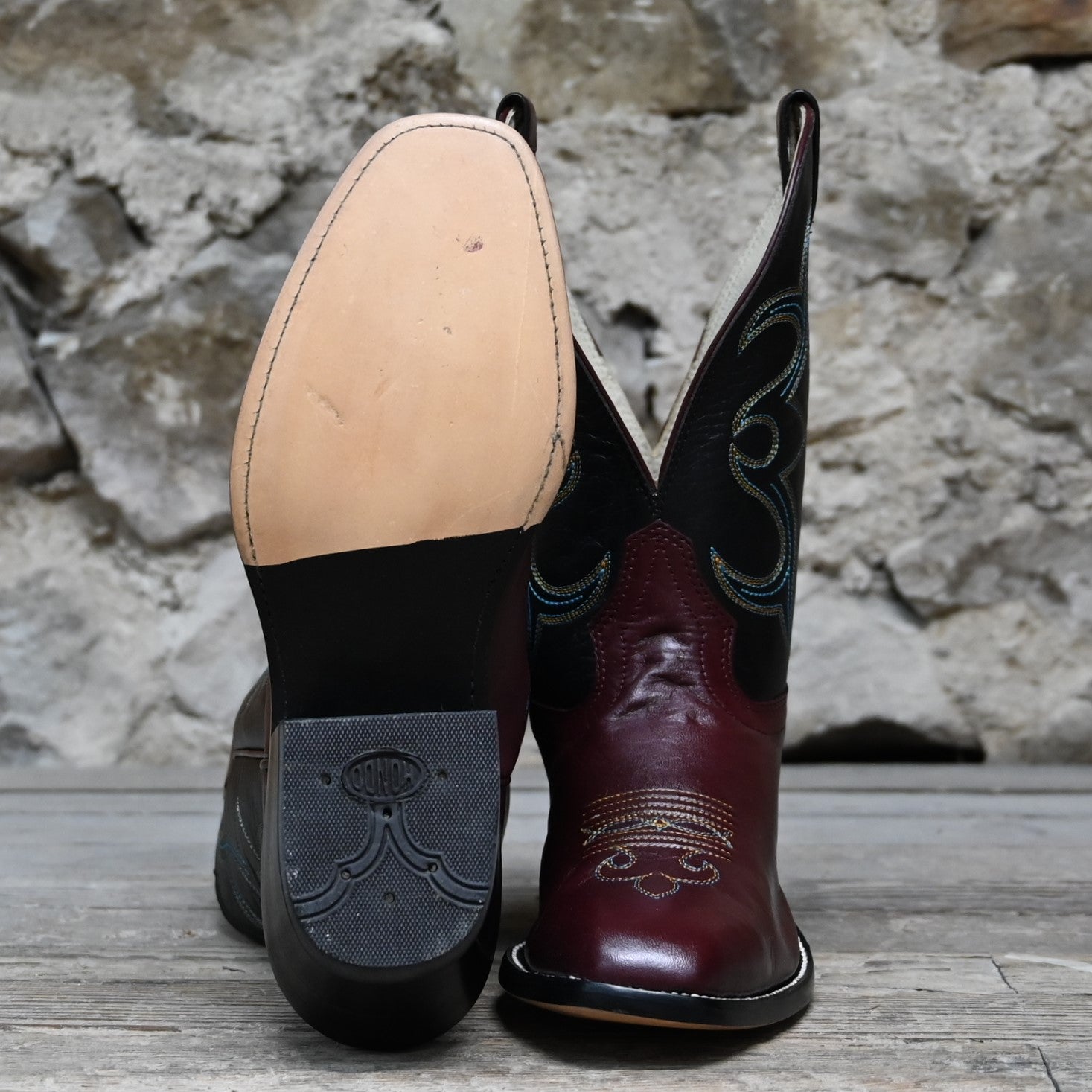 View of Atomic 79 exclusive Hondo Bronc Boot with black top, burgundy vamp, French square toe, and spur lip