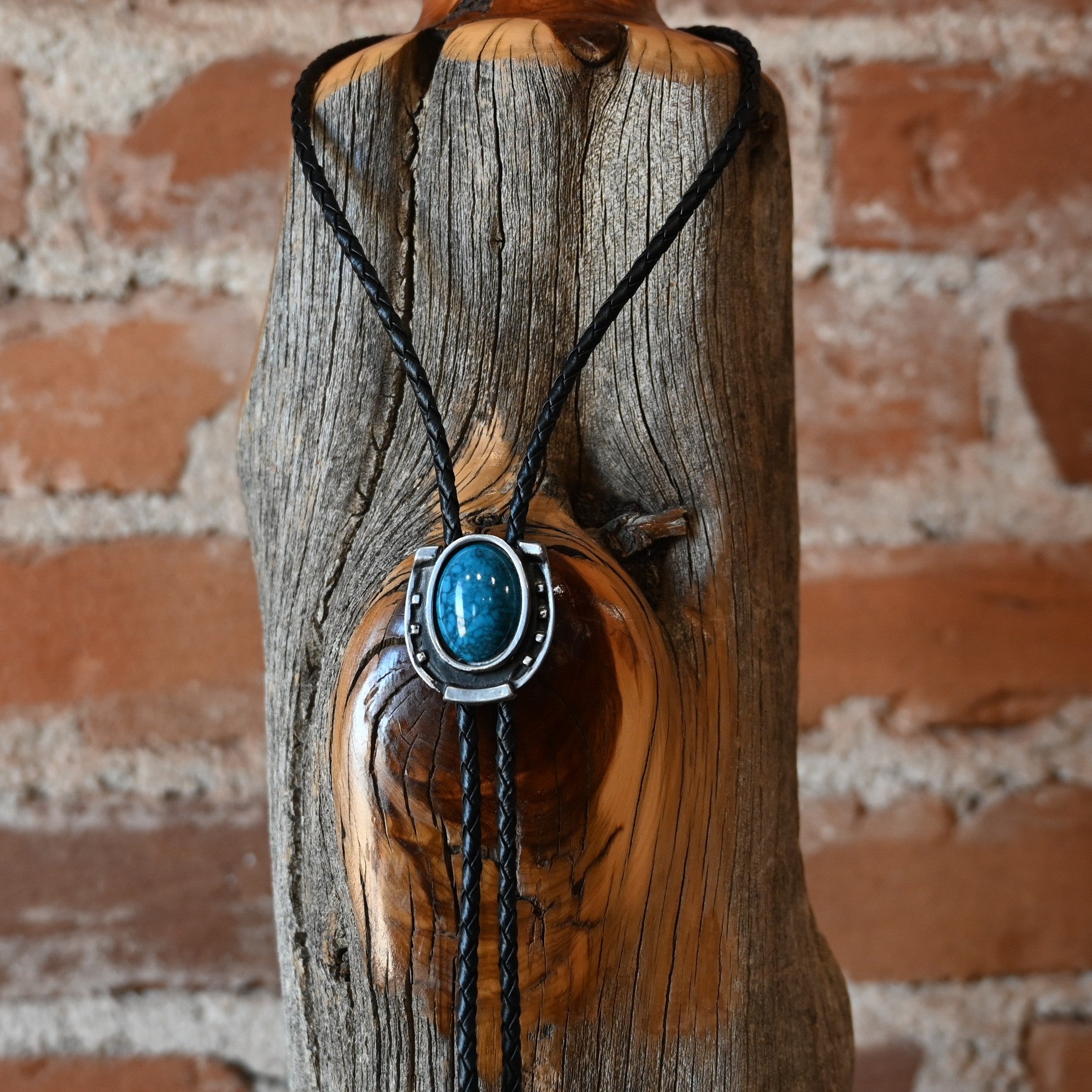 Rockmount Ranch Wear Horseshoe Bolo with turquoise stone and silver tips on black braided leather cord