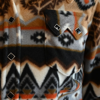View of Tan and black fleece Western shirt with Native geometric pattern and snap closures