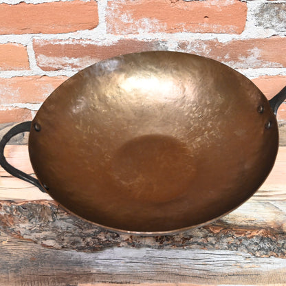 View of Smithey Ironware Carbon Steel Wok with hand-hammered surface and gooseneck handle