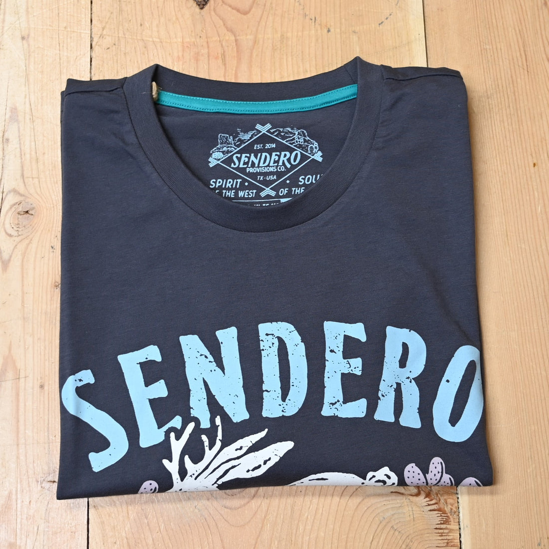 View of Sendero vintage black crop tee with jackalope and cactus desert scene graphic