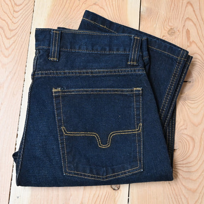 View of Kimes Ranch Watson jeans in Dark Indigo featuring hand-sanded details and bootcut leg