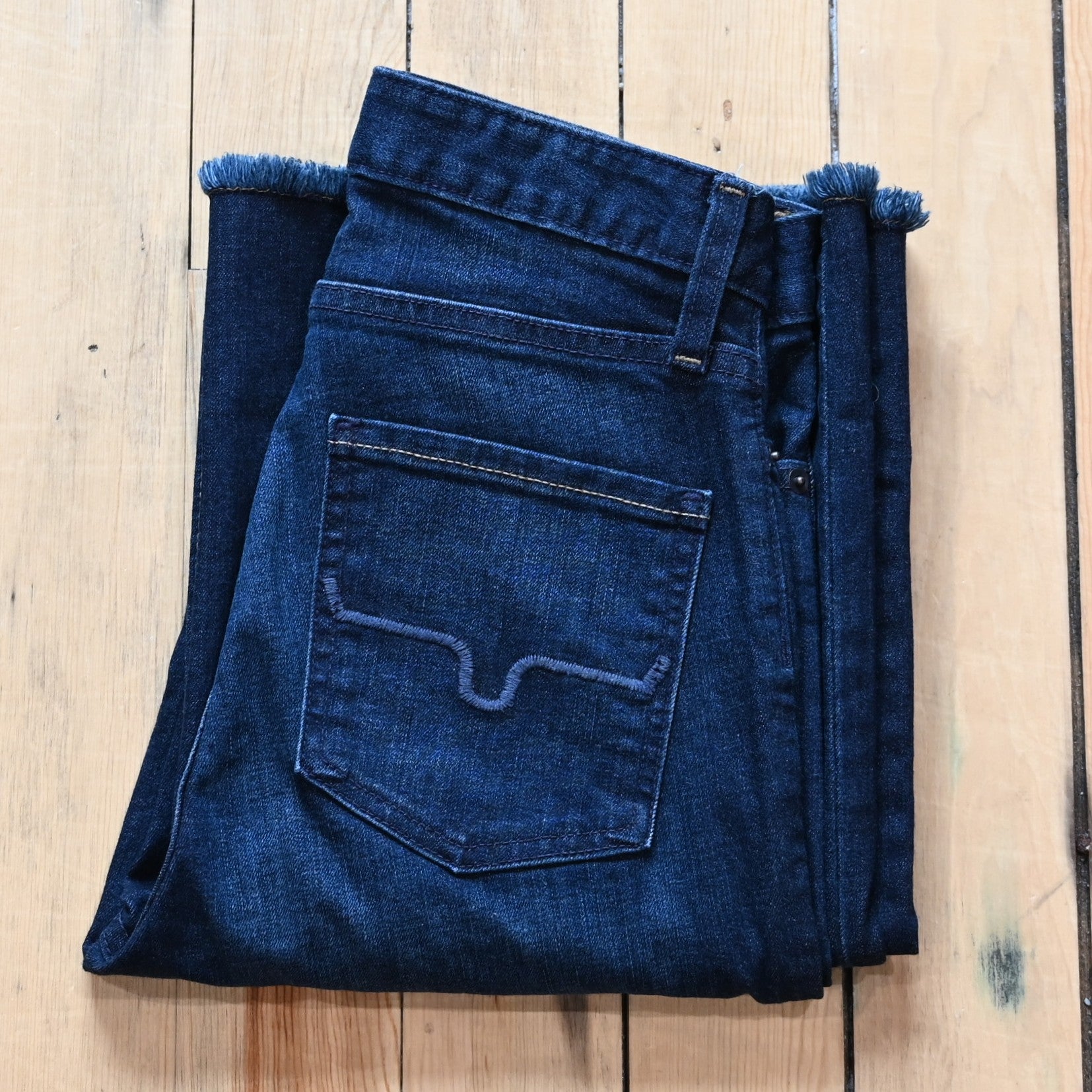 Kimes Ranch Olivia dark wash wide-leg jeans with raw hem and high-rise fit.