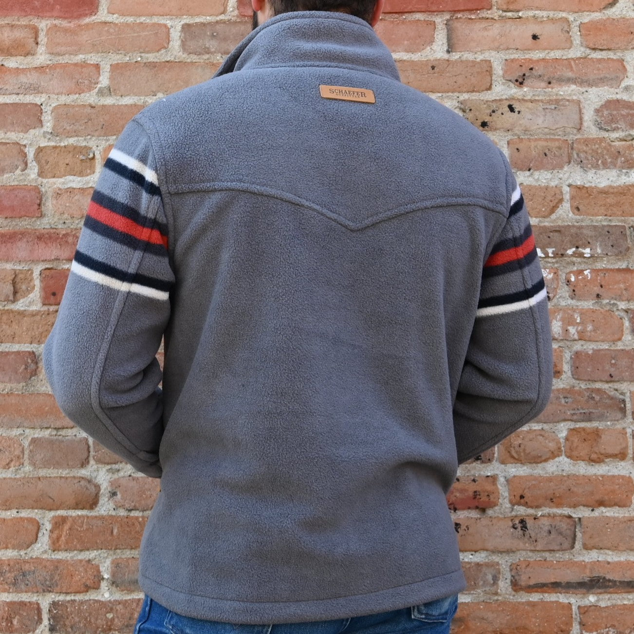 View of Schaefer Teton pullover fleece in Teton or Silverton color with storm collar and zip waist pockets