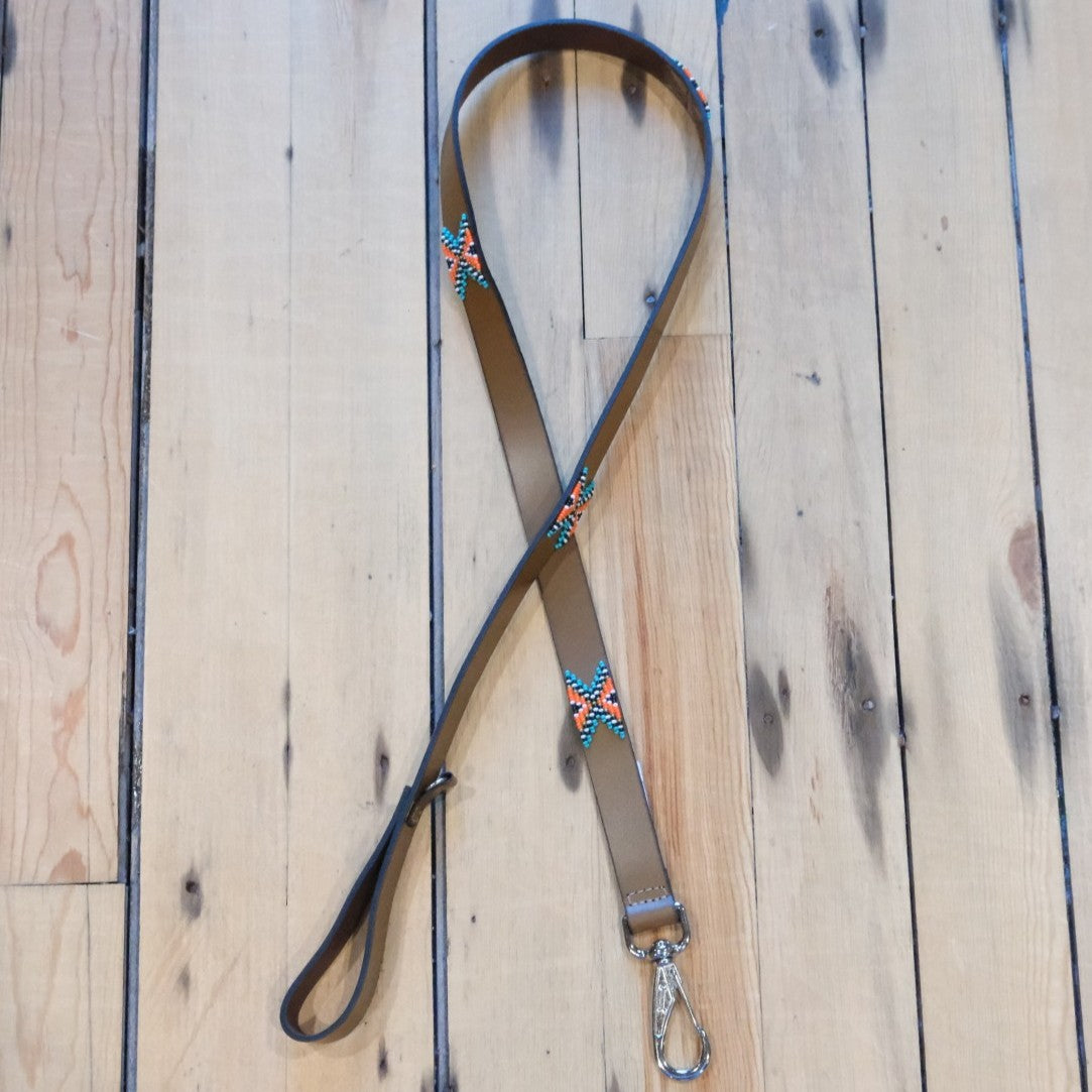 Sambboho Biarritz dog leash with turquoise, orange, white, and black beads on brown full-grain leather.