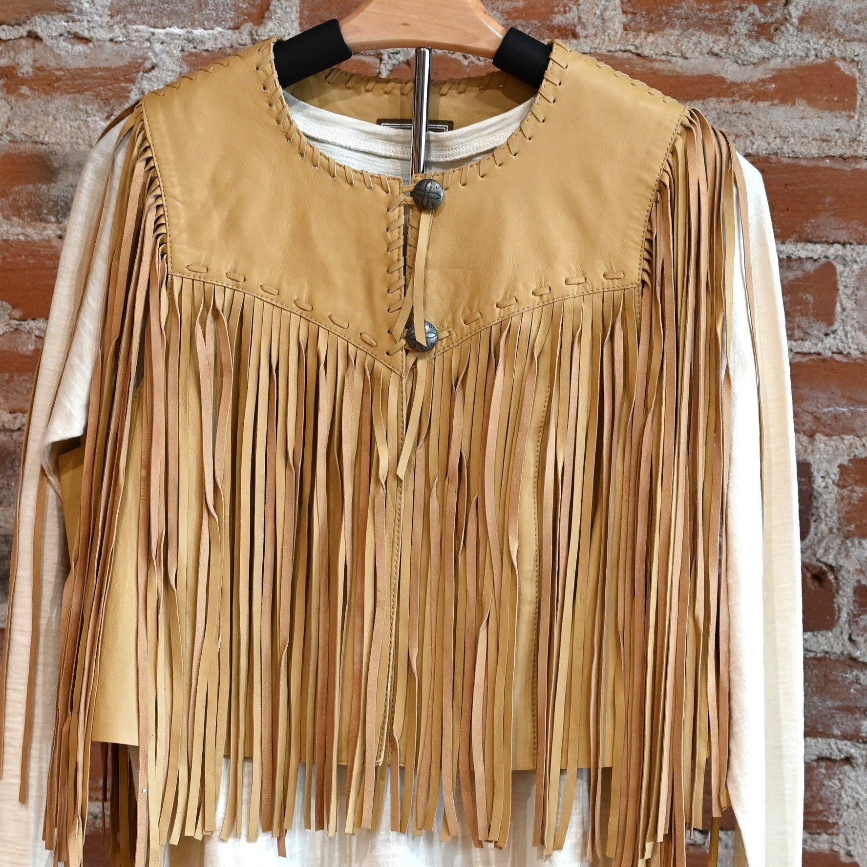 View of Double D Ranch Sonora Vest in Straw featuring full-length fringe and tonal leather lacing details