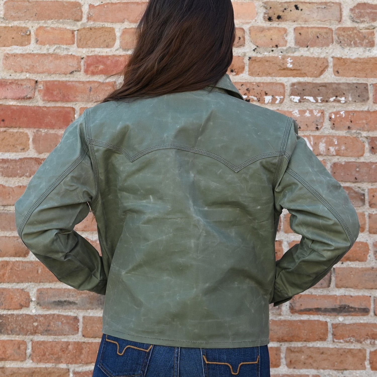 View of Schaefer ladies moss waxed canvas jacket with antique brass snaps and six pockets