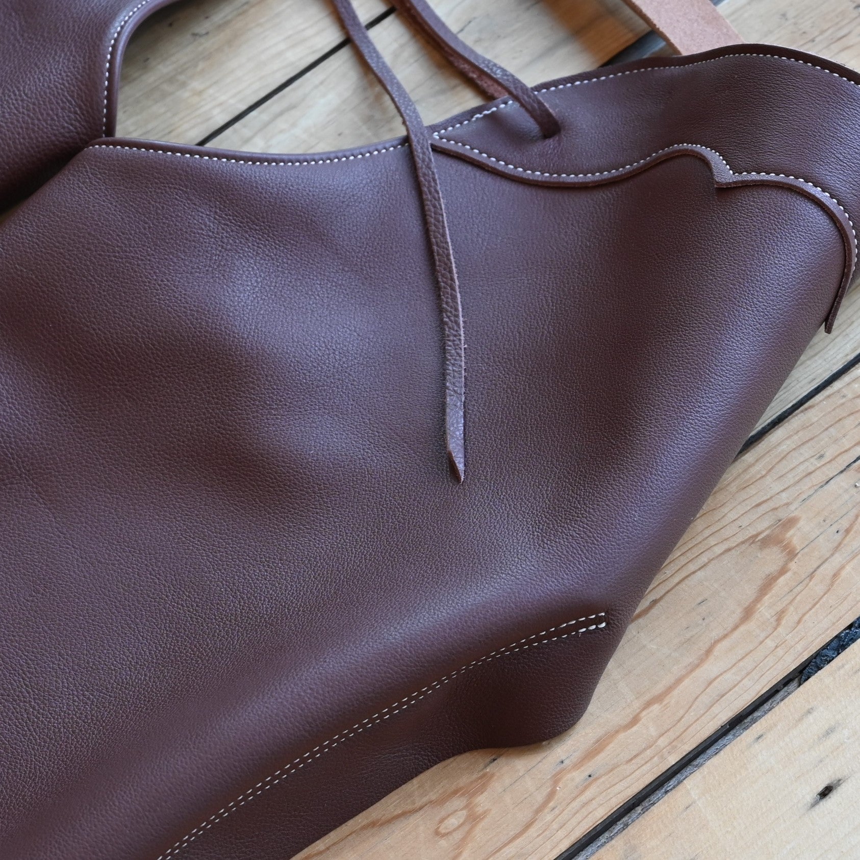 View of Weaver Shotgun Full Grain Chaps in brown oil-tanned leather with adjustable closures