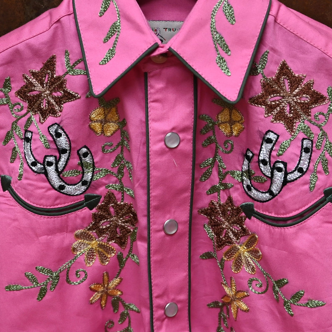 View of Pink Rockmount kids western shirt with embroidered flowers and horseshoes