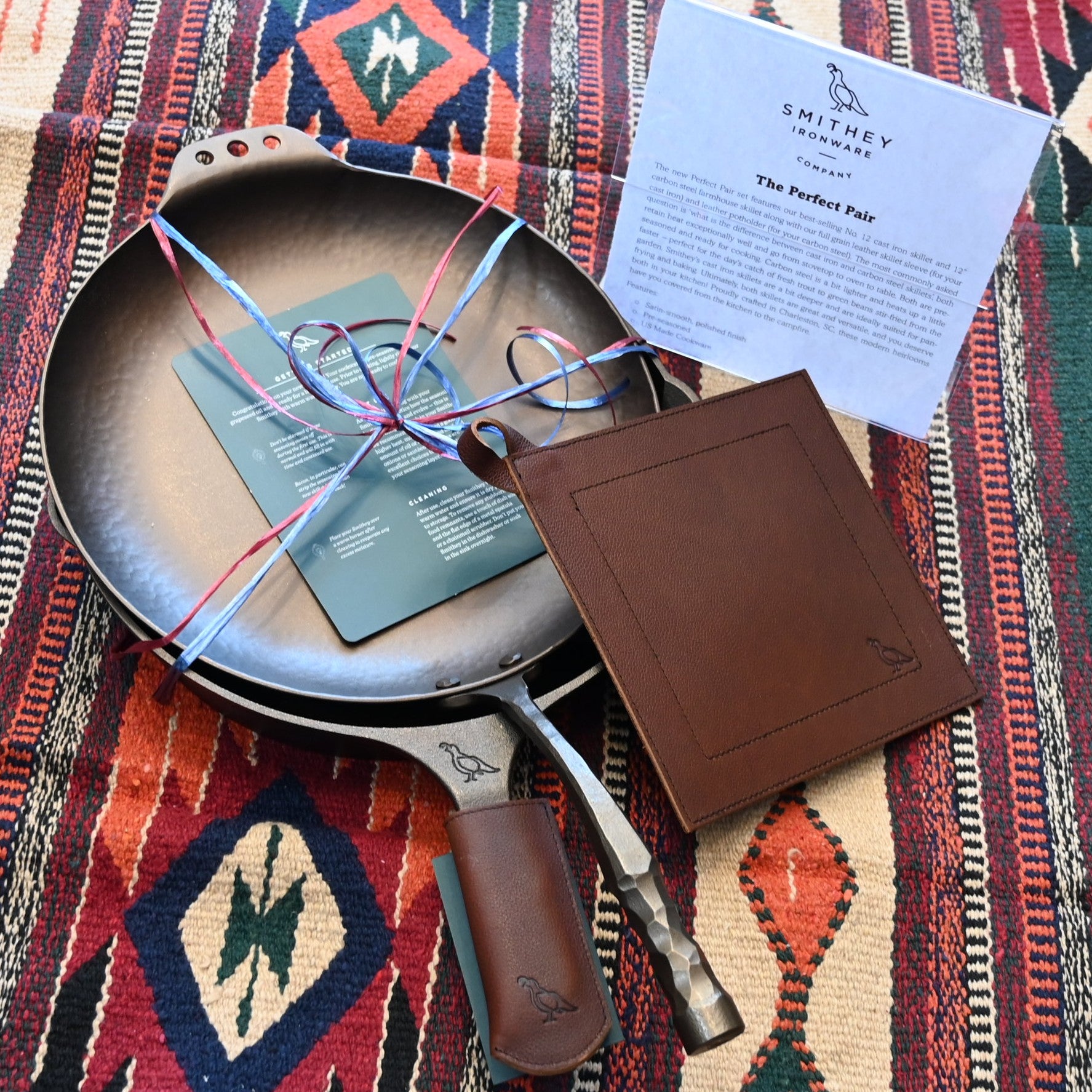 View of Smithey Ironware Perfect Pair Set: No. 12 Cast Iron Skillet and 12&quot; Carbon Steel Farmhouse Skillet with full grain leather sleeve and potholder