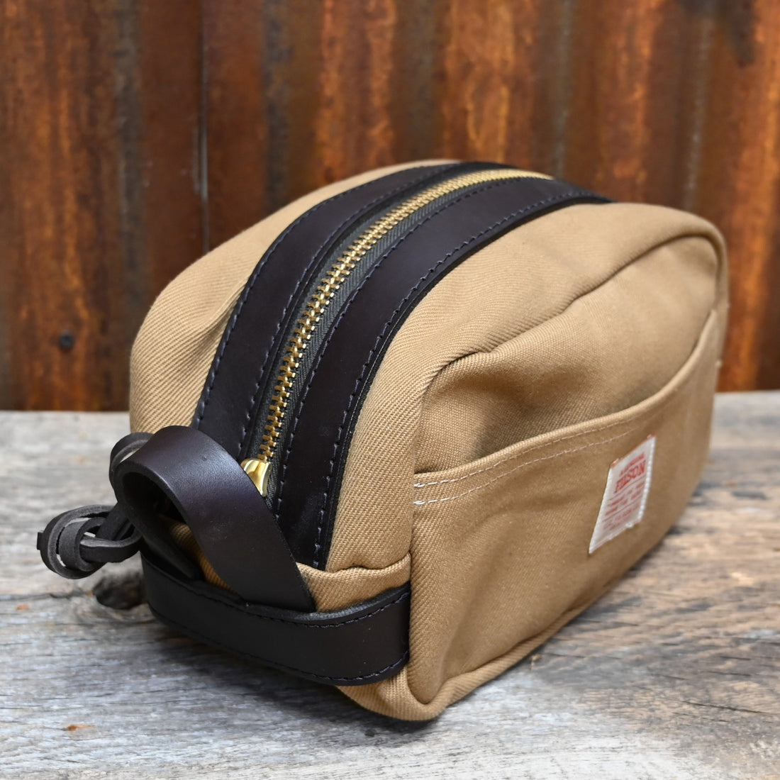 View of Filson Lightweight Travel Kit with Leather Loop in Tan featuring Bridle Leather accents and waterproof nylon lining