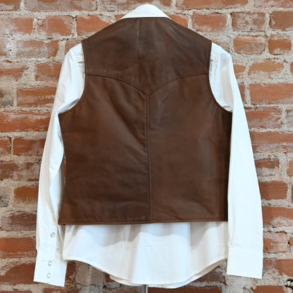 View of Schaefer ladies whiskey leather vest with Western yoke, snap front, and interior pockets