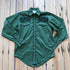 View of Green Western shirt with embroidered “man and rider” motif across yokes and cuffs
