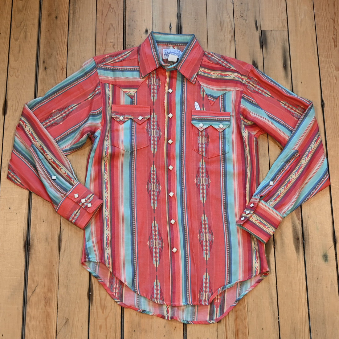 View of Rockmount men’s coral serape stripe western shirt with diamond snaps and sawtooth pockets