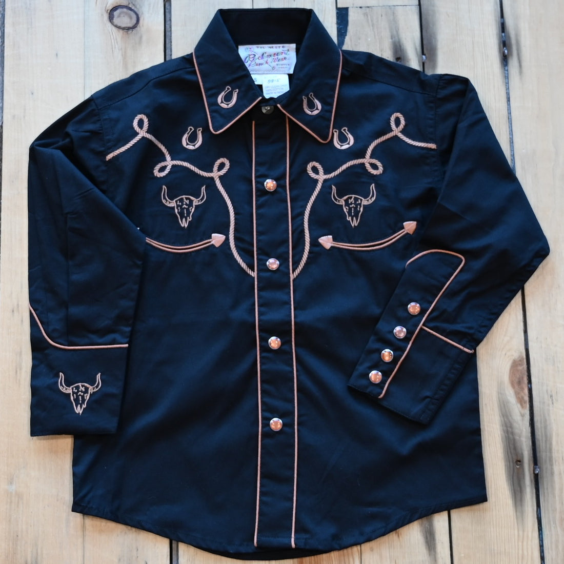 View of Rockmount Kids black western shirt with steer, horseshoe, and rope embroidery