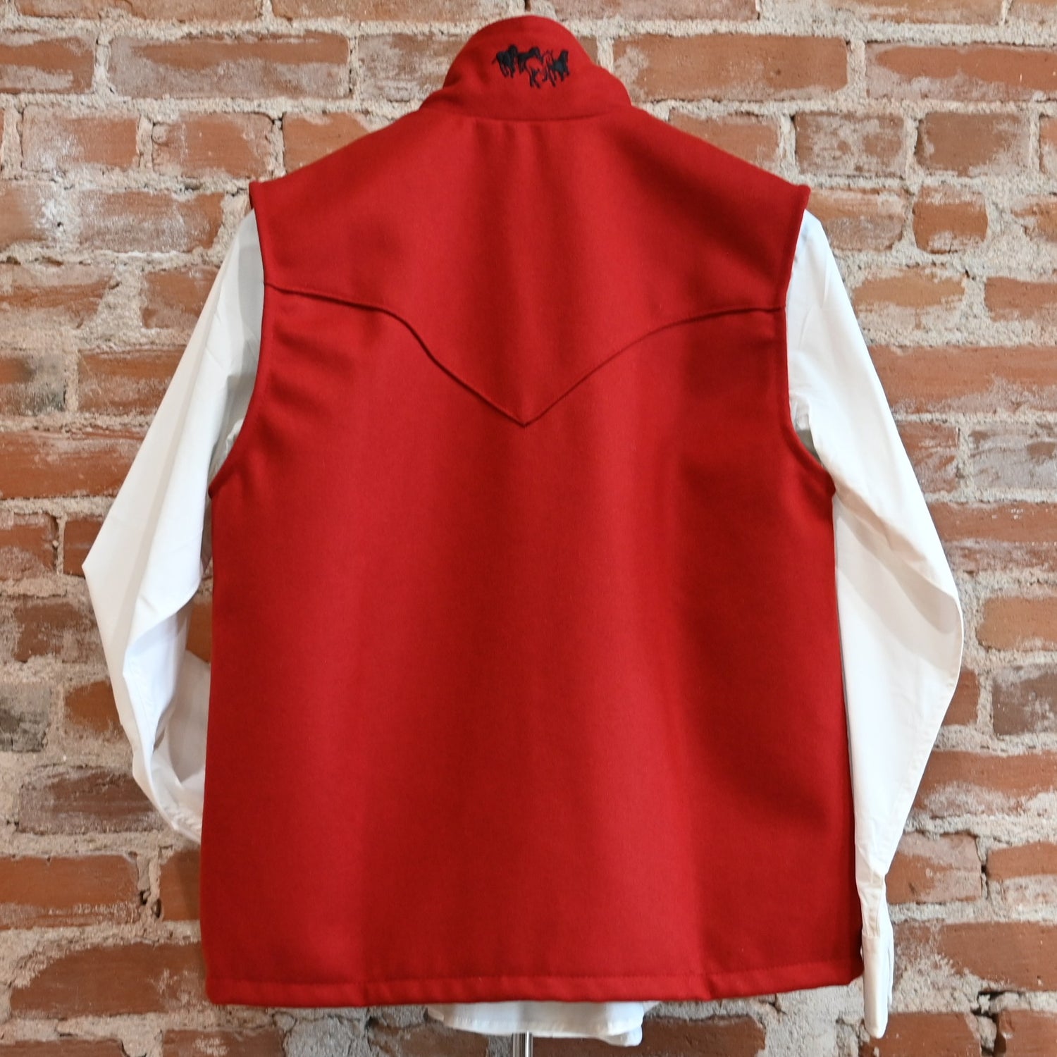 View of Schaefer ladies wool Arena vest in black or red with Western yokes and storm-flap zip front